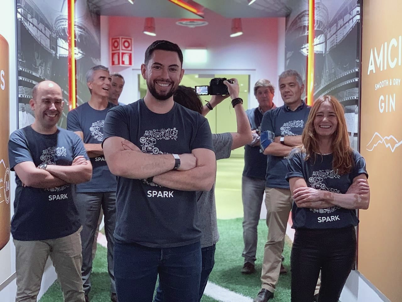 Gruppo in piedi durante un workshop di innovazione, sorridente per la foto
